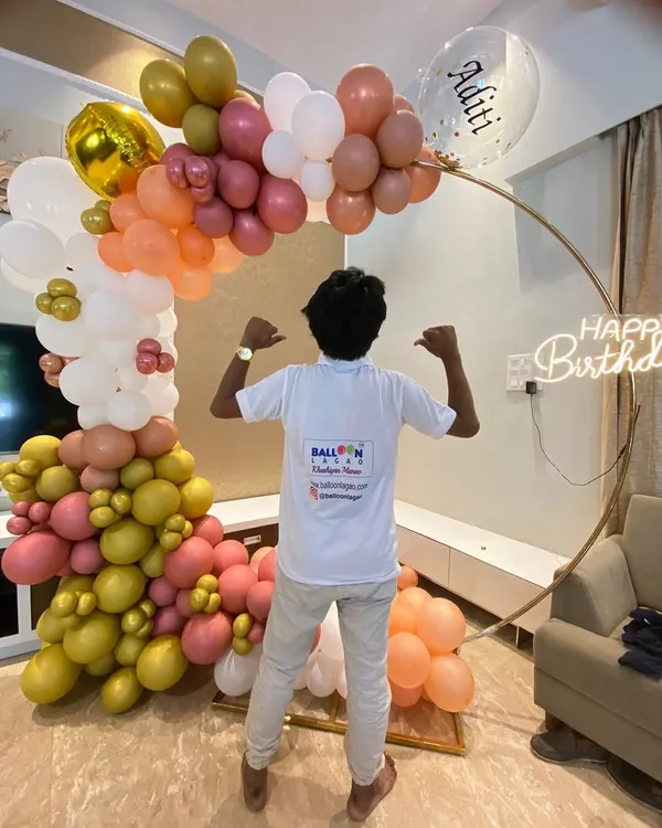Our team member proudly showcasing a finished birthday ring garland. We love seeing our hard work come together to create a beautiful celebration piece.