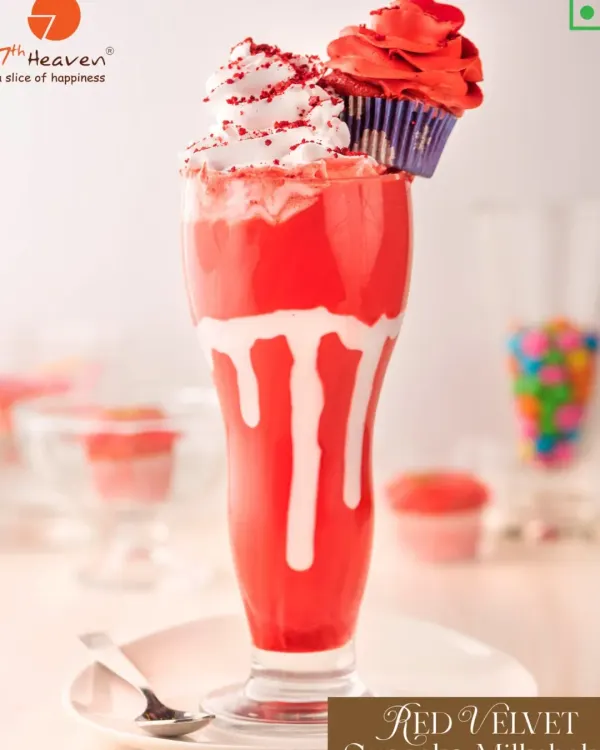 This is our iconic Red Velvet Cupcake Milkshake. It's a rich, creamy red velvet shake topped with whipped cream, red velvet crumbs, and a whole mini cupcake. It's a drink and a dessert all in one, perfect for a celebration or when you just want to treat yourself.