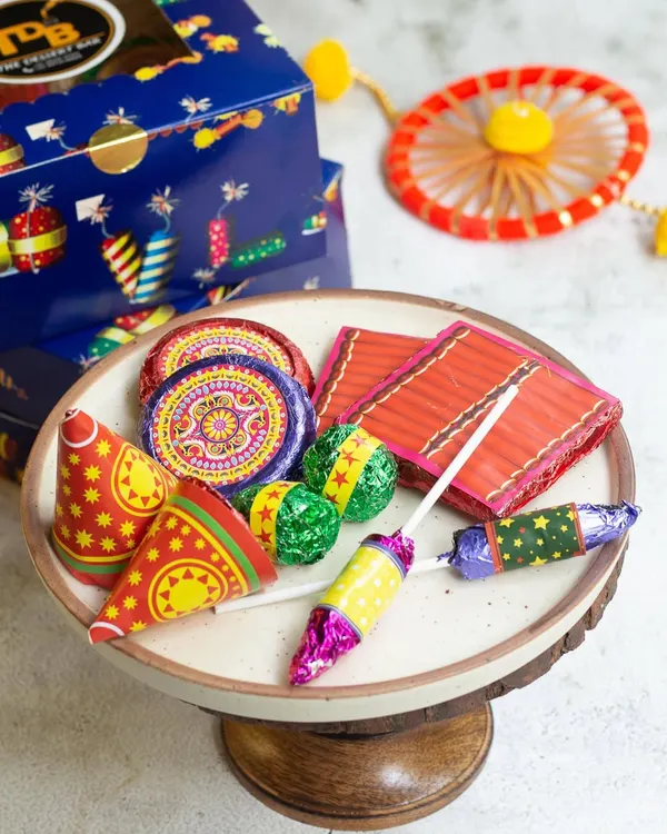 My edible Diwali Patakha Box is a fun and safe way to celebrate the festival of lights. It's filled with chocolate crackers, biscuit chakris, and dry fruit laddu bombs, making it a perfect and unique Diwali gift for all ages.