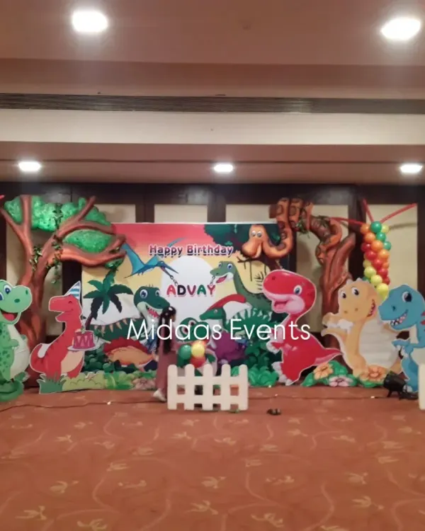 This is the main stage for Advay's dinosaur-themed party. I used a combination of a printed backdrop, large friendly dinosaur cutouts, and tree props to create a complete prehistoric scene for the cake-cutting ceremony.