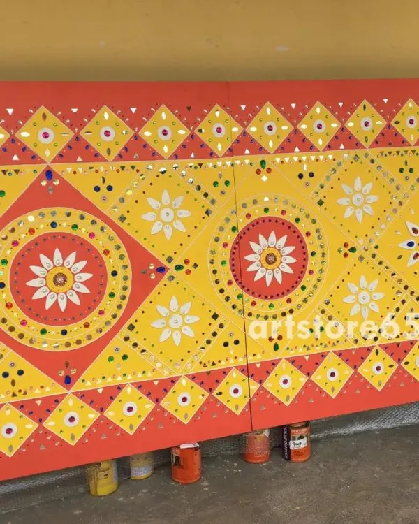 A finished Lippan wall panel featuring traditional geometric and floral patterns from Kutch. The bright yellow and red color scheme is classic, making it a vibrant addition to any interior design seeking an ethnic touch.