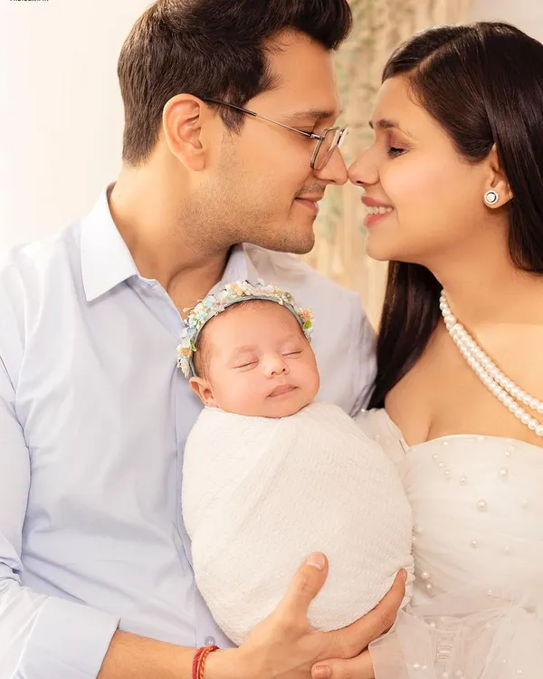A peaceful moment between new parents and their sleeping baby. I specialize in creating serene and beautiful portraits that capture the love of a new family.