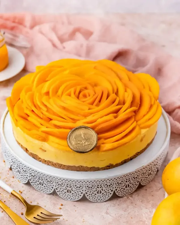 A preview of our mango collection. This is our Mango Cheesecake, featuring a beautiful rosette of fresh mango slices on top of a creamy, homemade aamras-infused filling.