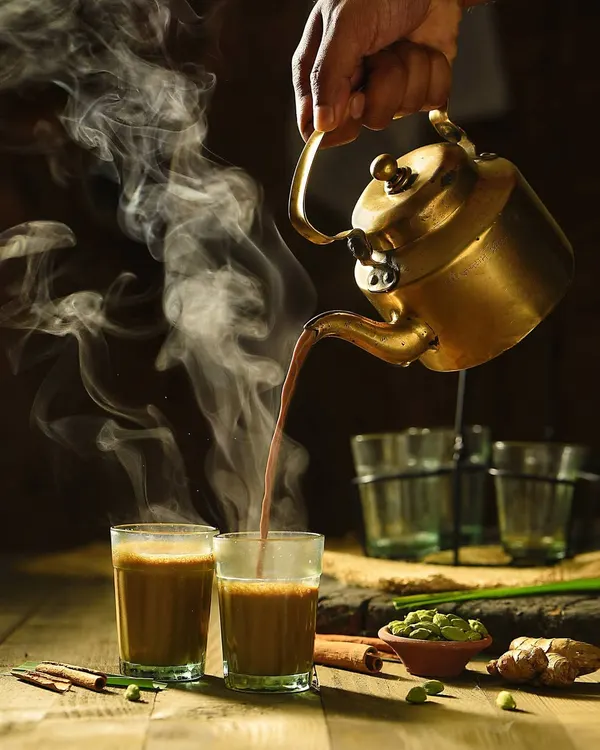 This shot is all about the vibe. I wanted to capture the feeling of a perfect cup of masala chai, focusing on the dynamic action of the pour and the swirling steam. This kind of beverage photography uses moody lighting to create an atmosphere that you can almost feel and taste.