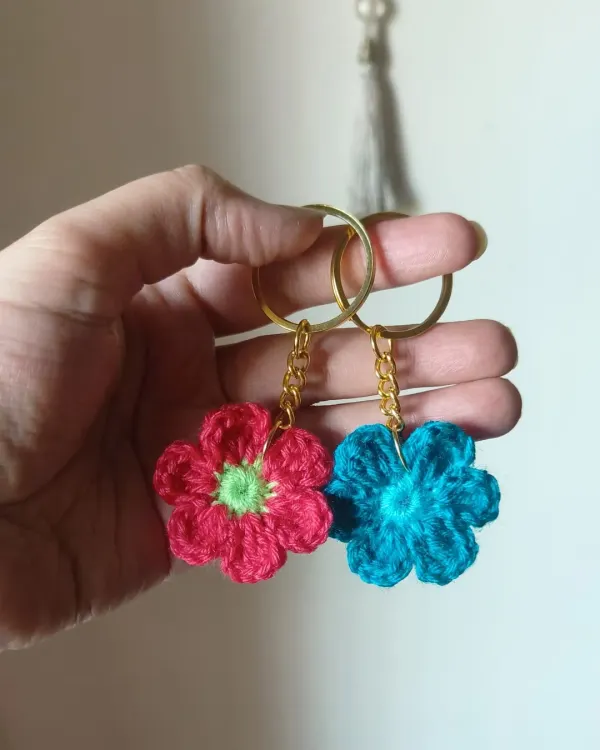 Our floral keychains are a small pop of color for your everyday essentials. Here are two examples, one in bright pink and the other in a lovely turquoise.