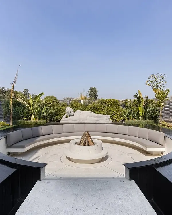 This circular sunken seating area, surrounded by a reflecting pool and a fire pit, is a sanctuary for heartwarming moments. Under the watchful gaze of a reclining Buddha, it is a space designed for connection and tranquility.