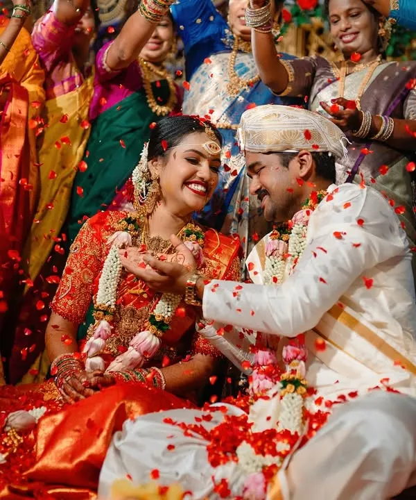 This is what pure joy looks like. We love capturing the peak moments of a South Indian wedding ceremony, like this traditional akshatharopanam ritual, where the couple is showered with blessings, rice, and flower petals.