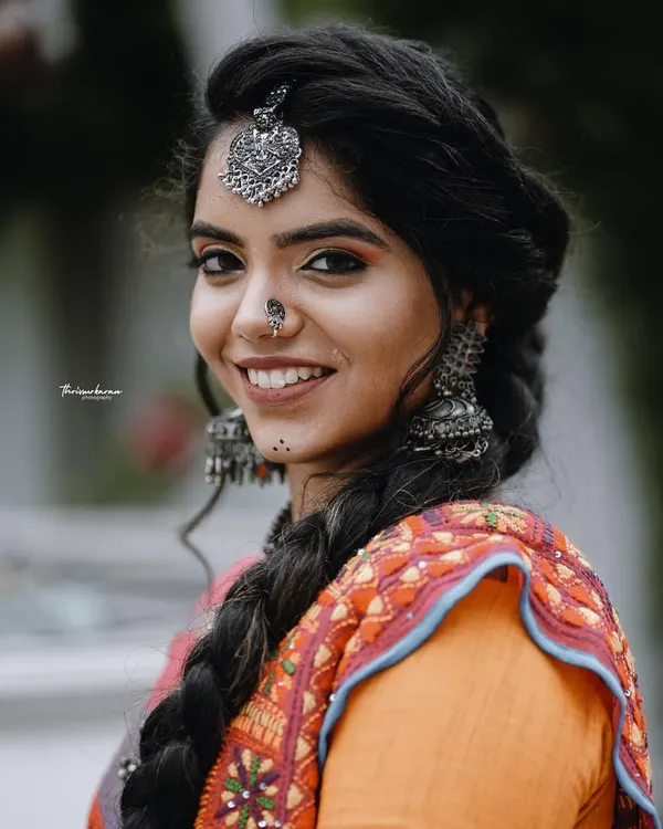 A beautiful portrait from a themed shoot, showcasing a model in a traditional-meets-modern outfit with striking silver jewelry.