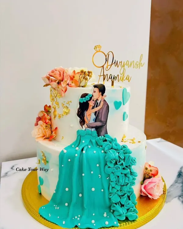 Two hearts, one cake, infinite memories. This handcrafted engagement cake features a beautiful couple illustration and a 3D floral dress effect.