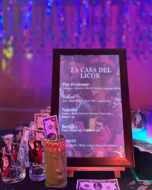 A close-up of the custom 'La Casa Del Licor' menu I created for a Money Heist themed sangeet, with cocktails named after characters like 'The Professor' and 'Tokyo'.