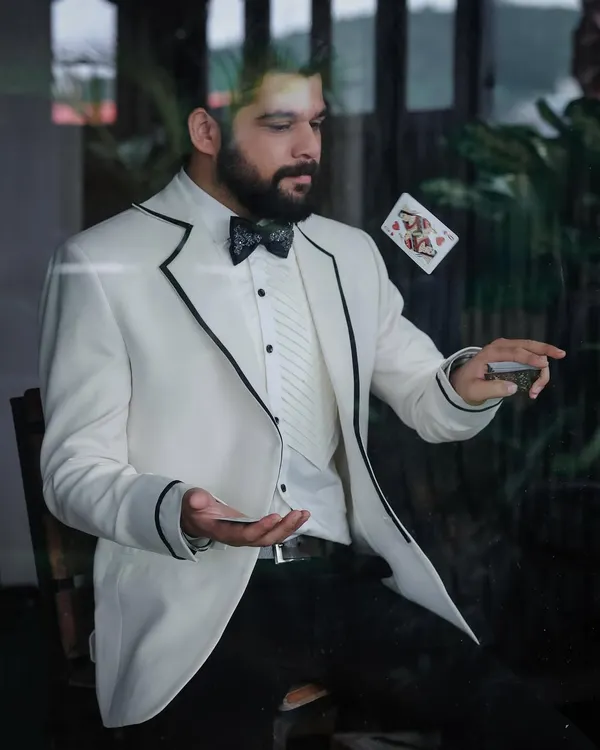 An action shot from Kshitish Date's photoshoot, where the crisp white tuxedo allows for dynamic and engaging portraits.
