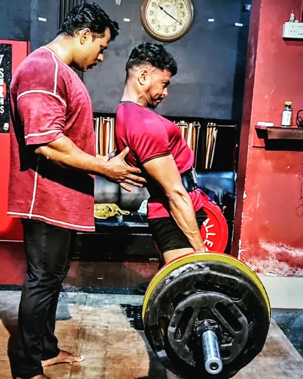 Correcting the deadlift posture is crucial. I am right there to provide tactile cues to ensure the back is set and the lift is safe and powerful. This is my coaching method.