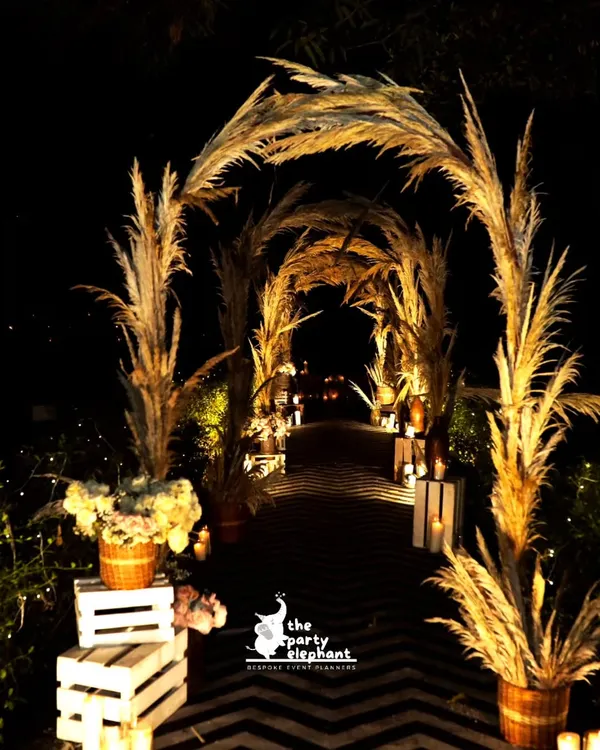 The entrance to this 40th birthday was designed to be dramatic and enchanting. I created a beautiful arched walkway using pampas grass, illuminated to create a warm glow and a stunning first impression for guests.