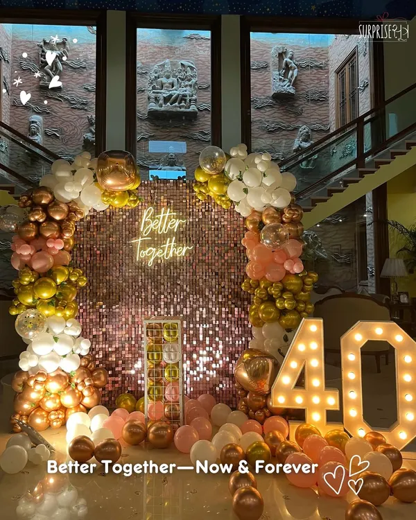 Better together, now and forever. This grand setup for a 40th anniversary featured a stunning rose gold sequin wall, a lush balloon arch, and marquee numbers to celebrate four decades of love.