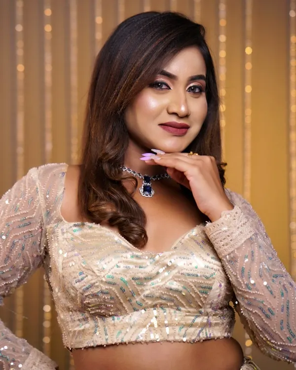 A soft, glamorous hairstyle with gentle waves, perfect for a reception or cocktail party. This look adds volume and movement, complementing the modern sequined lehenga.