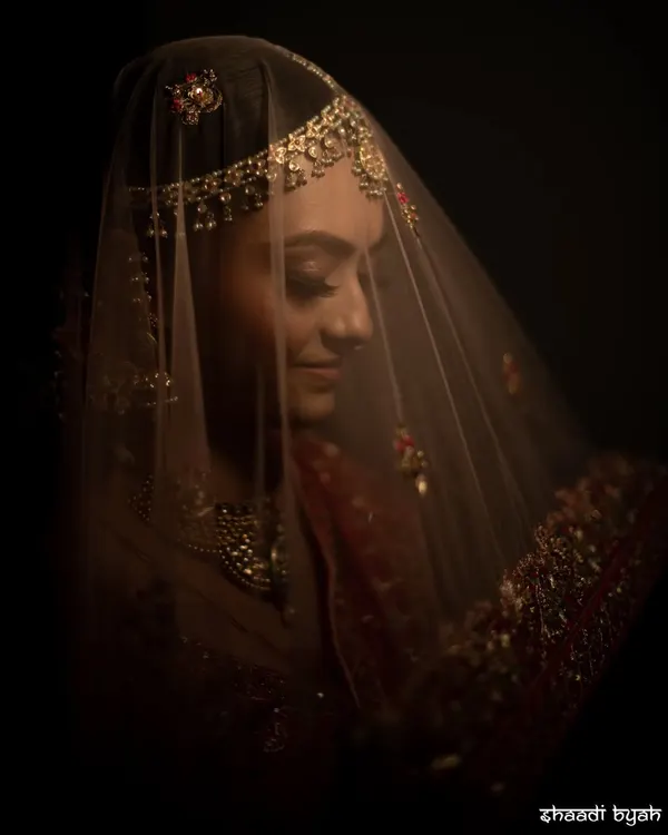 "In a world full of trends, she wanted to be a classic." A moody, artistic portrait of a bride under her veil, creating a timeless and mysterious look.