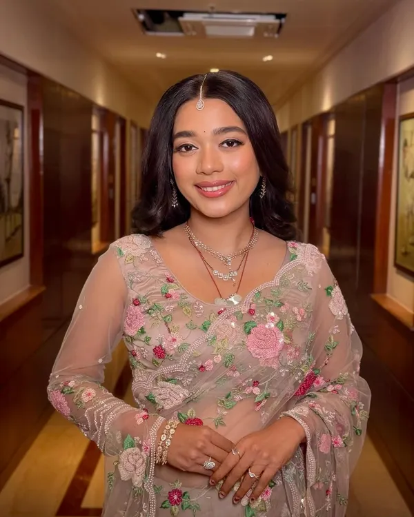 She was a flower girl, blooming in every shade we used on her. This reception look is effortlessly glowing, with soft pinks and a radiant finish that complements her floral saree.