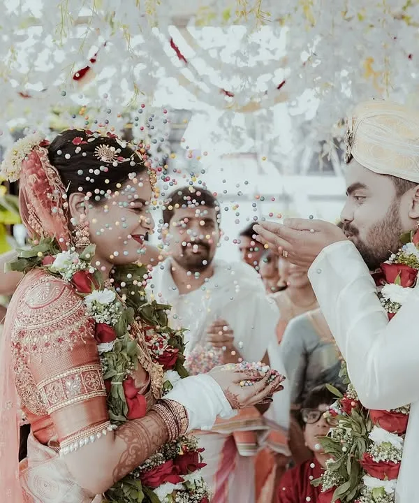 This is the kind of moment I live to capture. The pure, unscripted joy of a wedding ceremony, with rice and blessings showering the happy couple. It’s a candid shot that freezes a beautiful tradition in time.