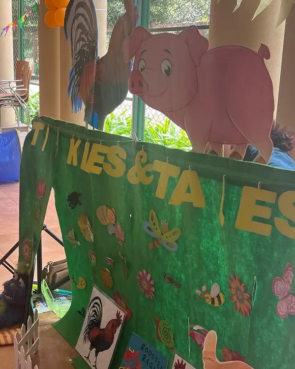 My portable puppet stage all set up for a farm animal adventure. The colorful banner and character cutouts immediately set a fun and inviting tone for the show.