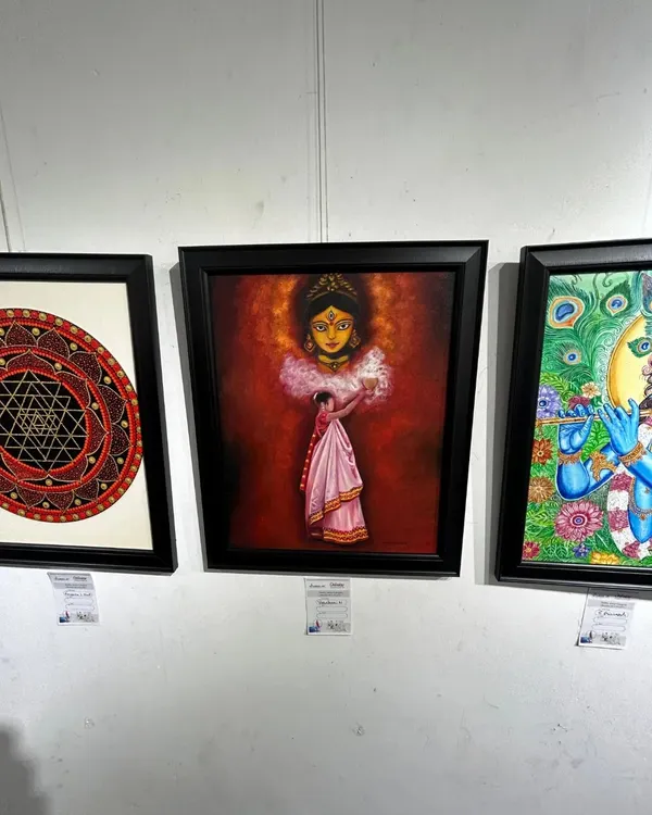 "The Worshipper of Durga" painting displayed at an exhibition, alongside other spiritual artworks.