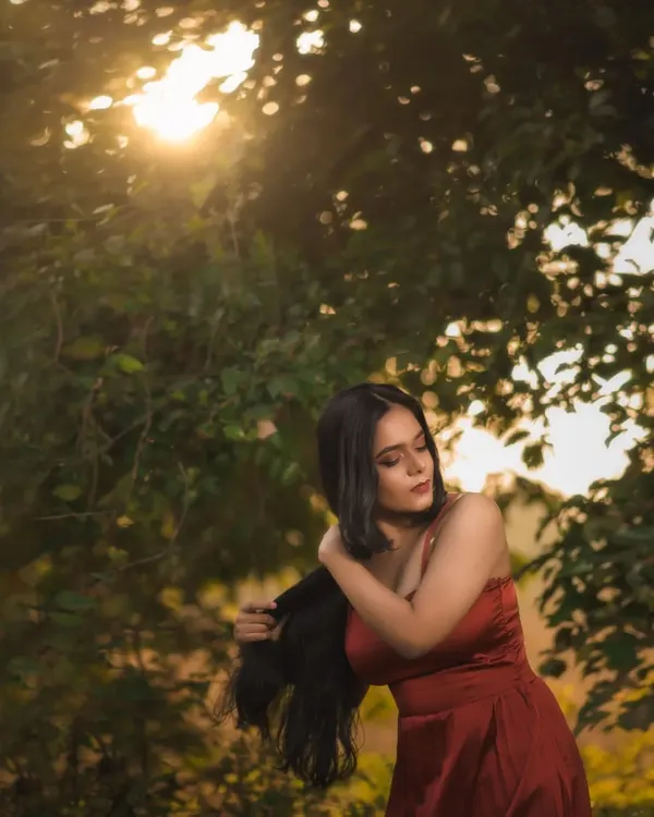 A shot from a golden hour session in a park. I love how the setting sun filters through the trees, creating a natural, warm light that's perfect for dreamy portraits.
