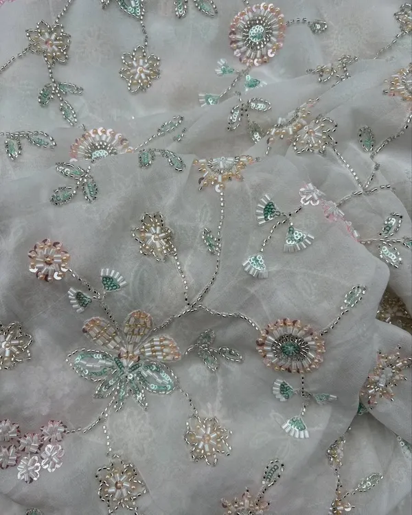 When embroidery gets a breezy twist. This embroidered georgette features delicate floral vines with sequins, creating a look that's both light and luxurious.