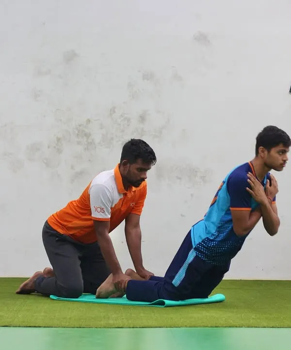 Our trainers provide support and guidance during every exercise. Here, a player performs a core-strengthening exercise with the assistance of a fitness coach.