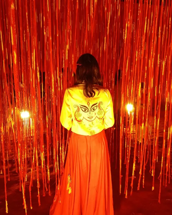 My hand-painted Durga jacket, designed for my first Garba event in Ahmedabad. Wearing your own art is a special feeling, and this piece, set against a vibrant red backdrop, truly captures the festive spirit.