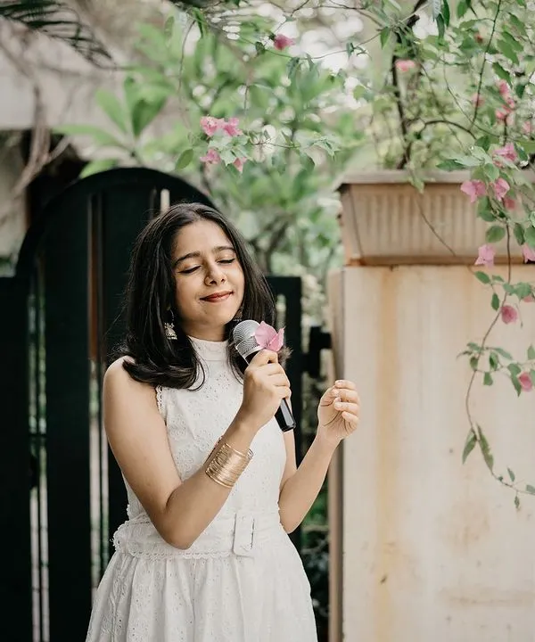 A professional shot from a performance, microphone in hand. This captures the joy and focus I bring to every live event, ensuring a memorable experience for you and your guests.