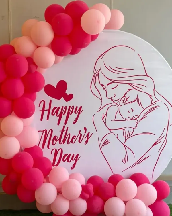 Show Mom some love with our beautiful Mother's Day decor. This simple and heartfelt design features a custom backdrop with a balloon frame in shades of pink and red.