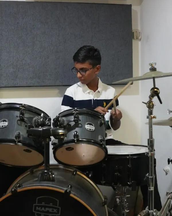 A quiet moment of a student learning and growing on the drums. Each lesson is different, but always moving forward.