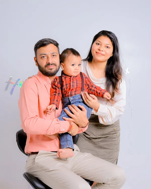 A classic family portrait with mom, dad, and the birthday boy. We start the session with these clean shots before the cake comes out.
