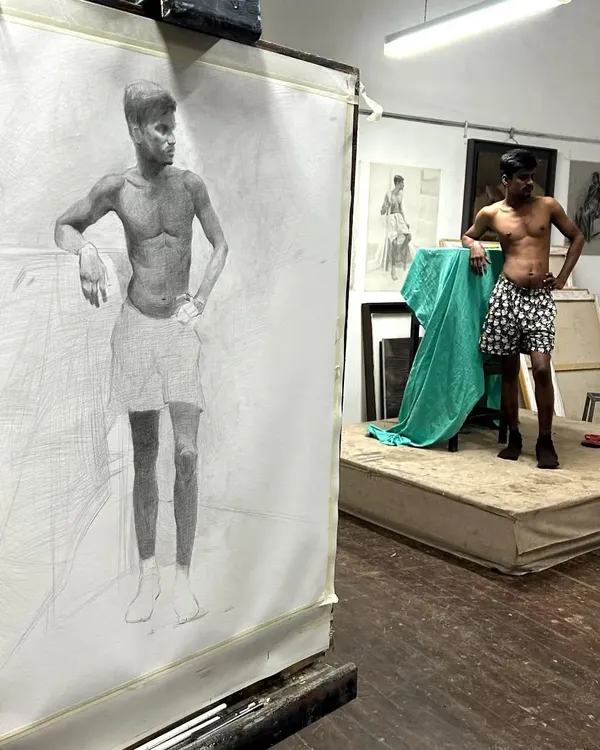A life drawing session at J.J. School of Art, showing my large-scale graphite drawing next to the model. This is the foundation of understanding human anatomy.