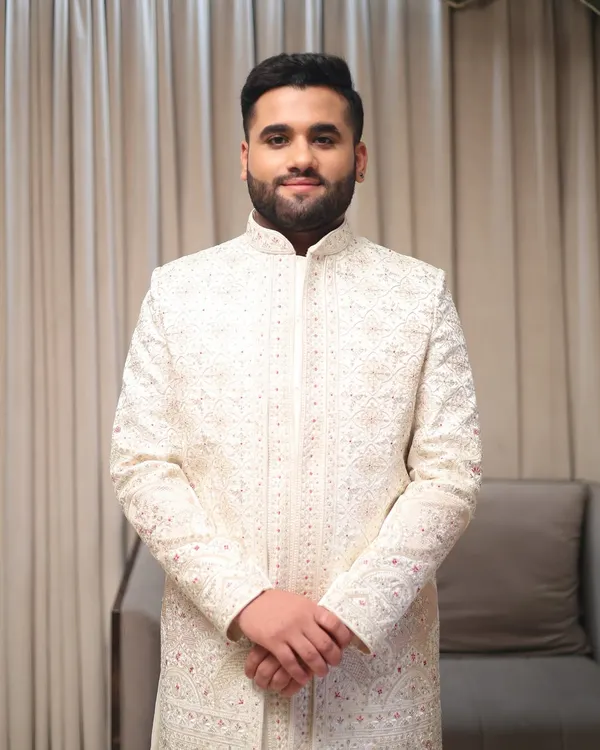 A classic portrait of a groom ready for his wedding. The makeup is kept natural to enhance his features, paired with a neatly styled beard and hair for a timeless look.