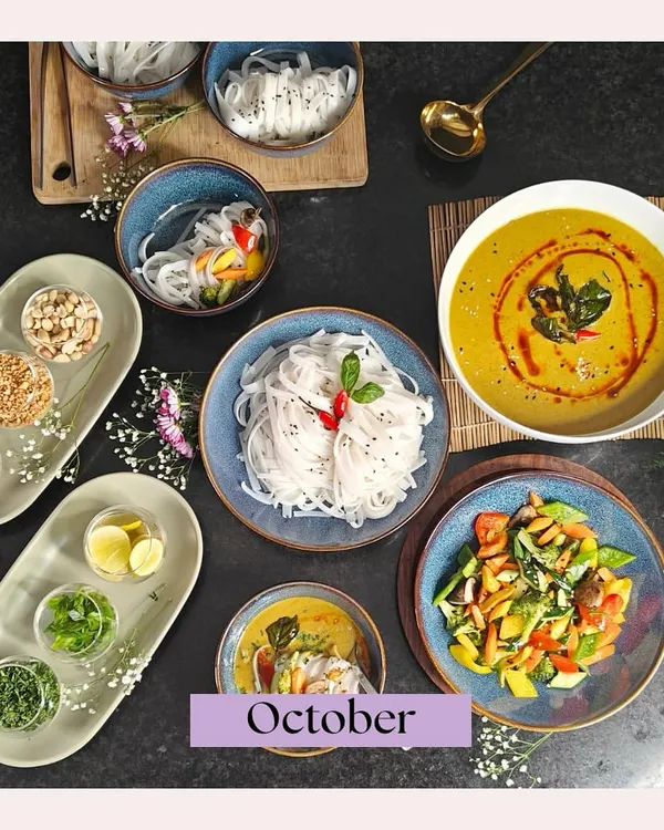 A beautifully deconstructed Khow Suey from our October highlights. This overhead shot shows the rich coconut curry, noodles, and a variety of fresh toppings, ready to be assembled into a perfect bowl.