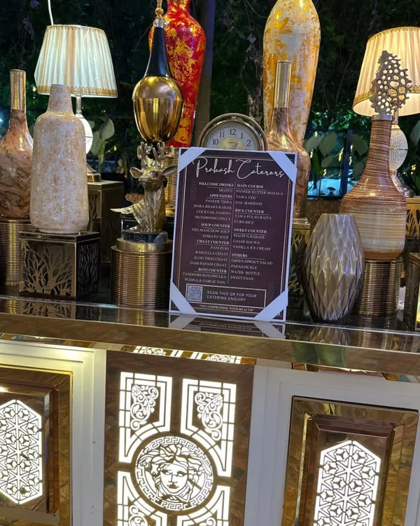 An elegant buffet counter featuring our detailed menu and decorative lamps. I ensure every detail contributes to a luxurious ambiance for your special day.