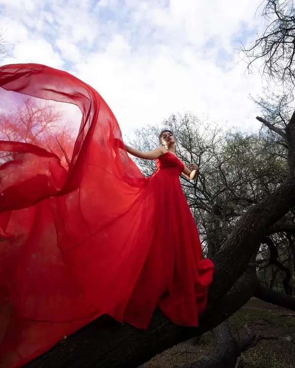 This is what fairytale moments are made of. My fiery red trail gown is designed for dramatic entrances and unforgettable pre-wedding photoshoots, ensuring you feel like a queen against any backdrop.