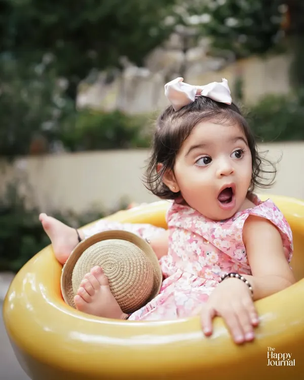 That look of pure surprise! This candid shot of a toddler in an outdoor setting perfectly captures the spontaneous and expressive nature of little ones.