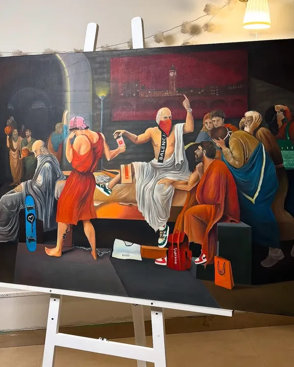 The 'Death of Socrates (hypebeast edition)' on the easel in my studio. This large-scale oil painting blends classical art with contemporary brands like Balenciaga and Supreme.