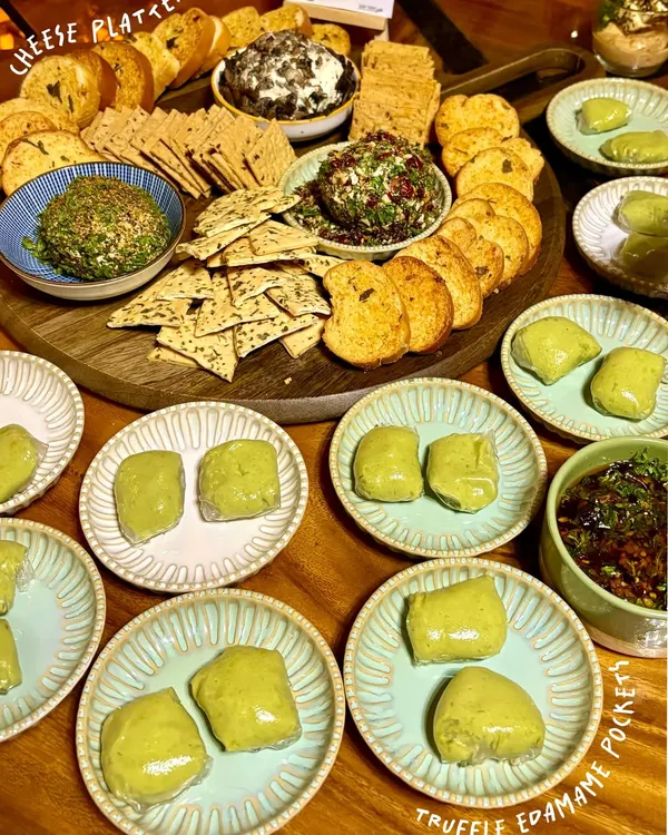 A stunning spread of our gourmet party starters, featuring creamy Truffle Edamame Pockets, a trio of artisanal Cheese Domes, and our addictive chilli cashew onion jam. This is how we make your gatherings unforgettable.