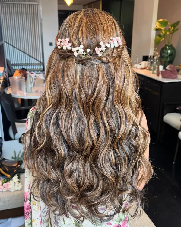 Flowy, stunning, and uniquely beautiful. This half-up, half-down style with soft waves and a delicate floral braid is perfect hair inspiration for a romantic, bohemian bride.