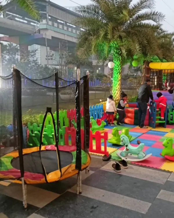 (Hero Media) I love creating complete outdoor party zones like this one, with something for everyone. This setup features a safe trampoline with a net, a colorful soft play area for the little ones, and a large bouncy castle in the background, ensuring hours of fun for all the kids.