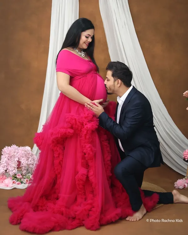A tender moment as the dad-to-be lovingly kisses the baby bump. This pose is a client favorite, beautifully capturing the bond between the couple and their unborn child in our studio.