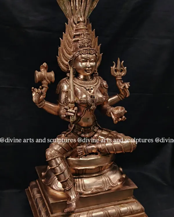 A bronze sculpture of Mahamariamman, a powerful form of the mother goddess. The five-headed serpent canopy and the intricate details of her weapons showcase our skill in complex iconography.