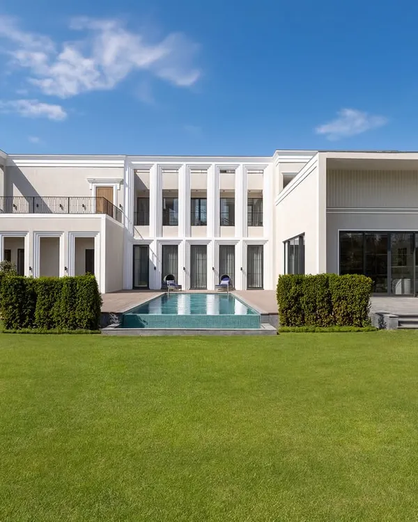 The facade of our Chhattarpur farmhouse project, showcasing clean lines, classical proportions, and an inviting connection between the home and the expansive landscape. We design for timelessness, creating exteriors that are as elegant today as they will be decades from now.