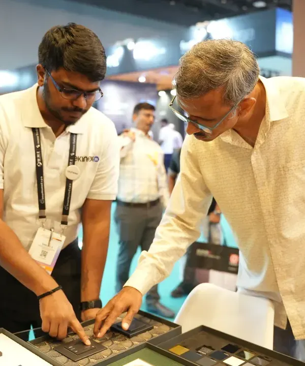 A visitor gets a hands-on demonstration of a smart switch panel, testing the tactile feel and responsiveness of the latest control interfaces.