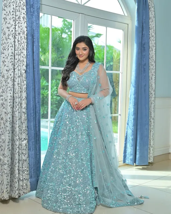 An ethereal ice blue lehenga covered in shimmering sequins. This rental is perfect for a winter wedding or a glamorous reception, giving you a unique, frozen-inspired look.