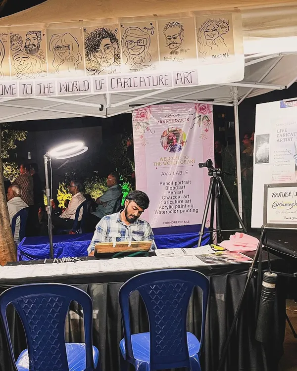 My complete live caricature setup at a night market, with my banner, ring light, and examples of my work on display. I'm always ready for any event.