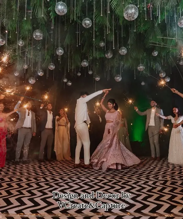 A magical sparkler entrance for the couple, with guests lighting the way under a canopy of hanging glass orbs for a truly cinematic moment.