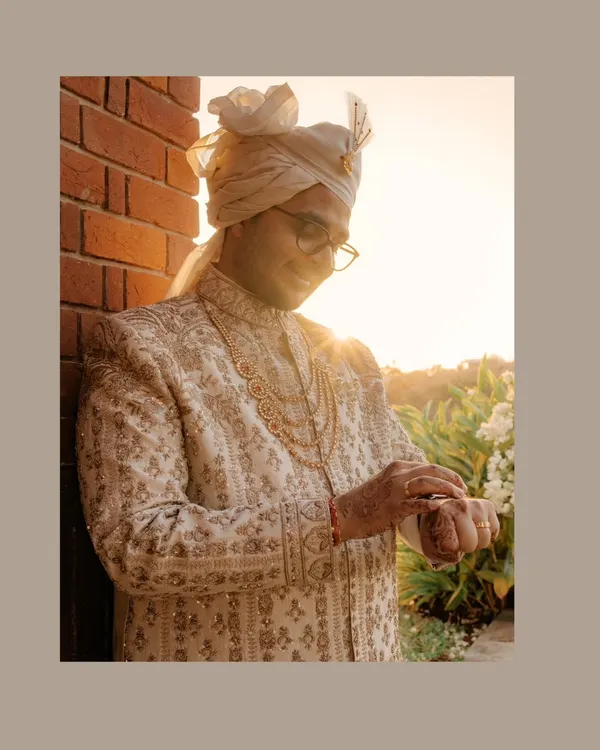 The golden hour for a golden groom. Sahas looks dapper in his intricately embroidered sherwani, the warm sunlight adding a magical glow to his wedding day portrait.
